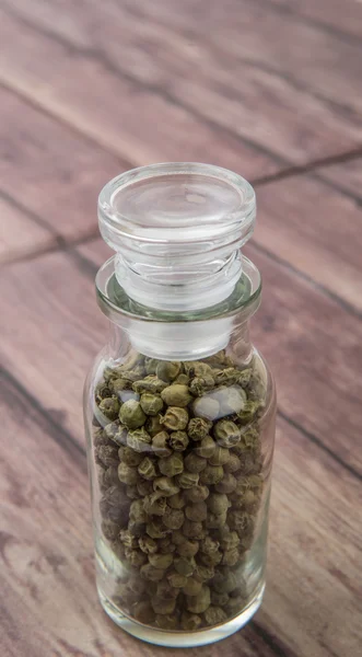 Grãos de pimenta verde em frasco de vidro — Fotografia de Stock