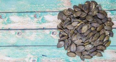 Ahşap arka plan üzerinde kavrulmuş kabak çekirdeği