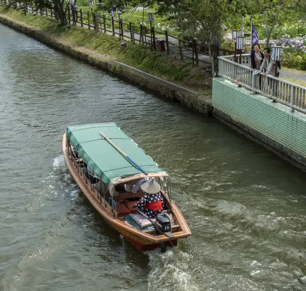 Locals and tourist riding a wooden boat — Stock Photo, Image