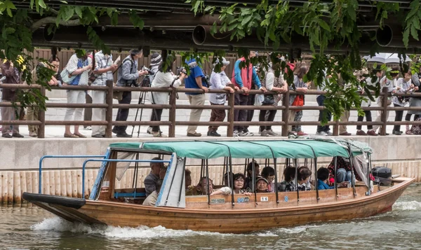 Locals and tourist riding a wooden boat — Stock Photo, Image