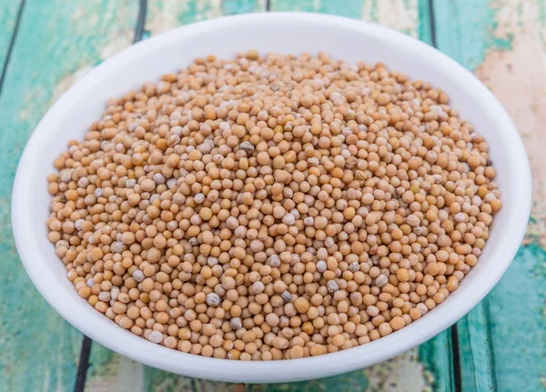 Mustard seeds in the white bowl — Stock Photo, Image