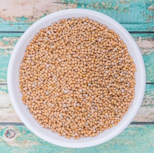 Mustard seeds in the white bowl — Stock Photo, Image