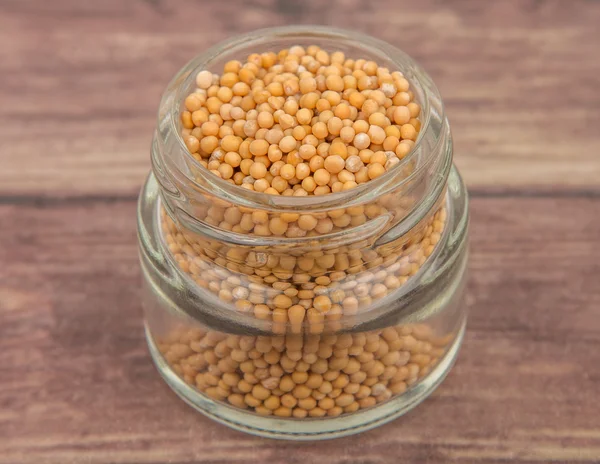 Mustard seeds in the glass jar — Stock Photo, Image