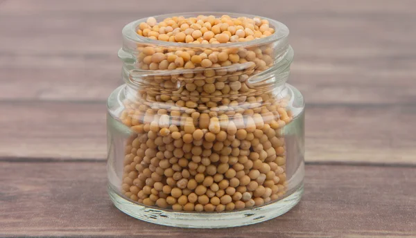 Mustard seeds in the glass jar — Stock Photo, Image