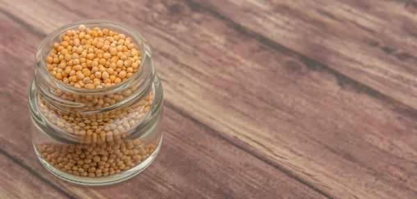 Mustard seeds in the glass jar — Stock Photo, Image