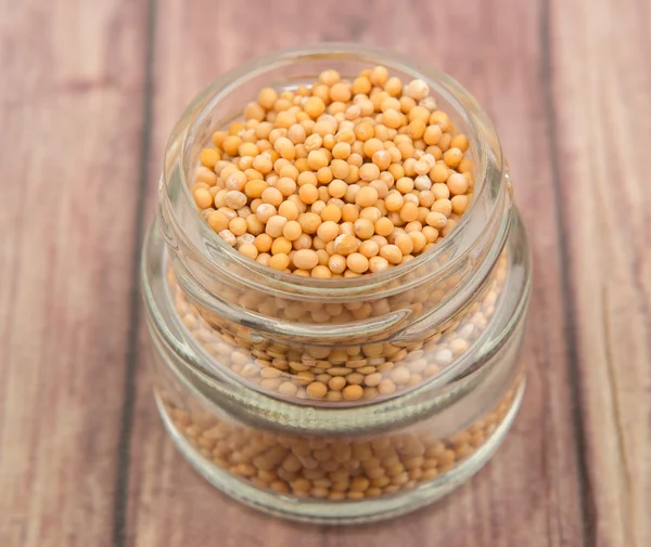 Mustard seeds in the glass jar — Stock Photo, Image