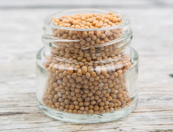 Mustard seeds in the glass jar — Stock Photo, Image