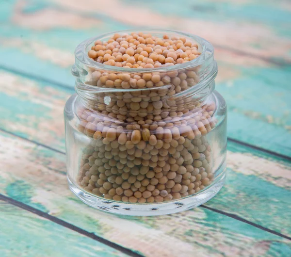 Mustard seeds in the glass jar — Stock Photo, Image