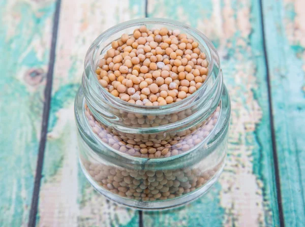 Mustard seeds in the glass jar — Stock Photo, Image