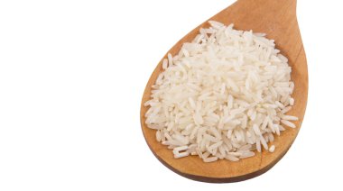 Raw and uncooked rice in wooden spoon over white background clipart