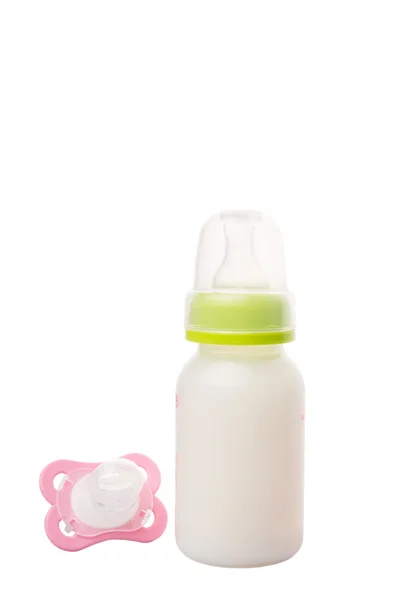 Baby Pacifier And A Bottle of Baby Formula Milk — стоковое фото