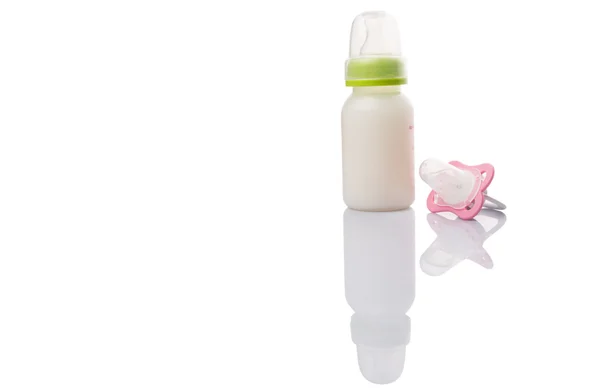 Baby Pacifier And A Bottle of Baby Formula Milk — стоковое фото