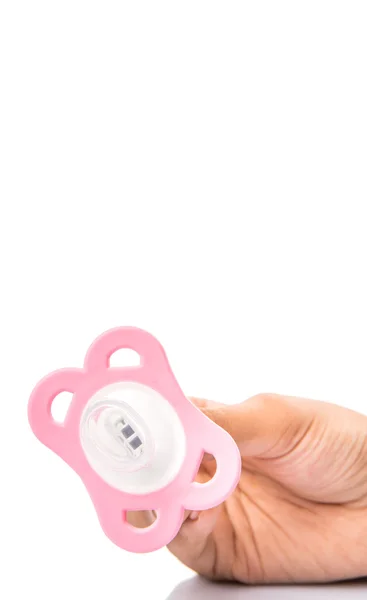 Female Hand Holding Pink Pacifier — Stock Photo, Image