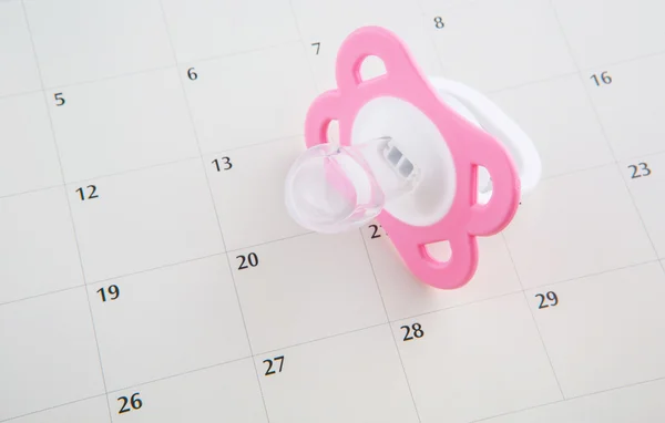 Ciuccio rosa e calendario — Foto Stock