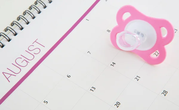 Rosa chupete y calendario — Foto de Stock