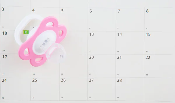 Ciuccio rosa e calendario — Foto Stock