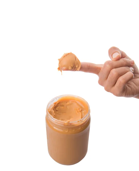 Dedo feminino com manteiga de amendoim — Fotografia de Stock
