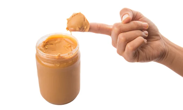 Weiblicher Finger mit Erdnussbutter — Stockfoto