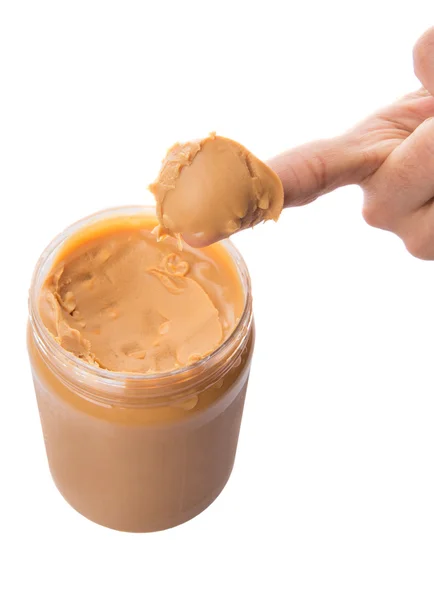 Weiblicher Finger mit Erdnussbutter — Stockfoto