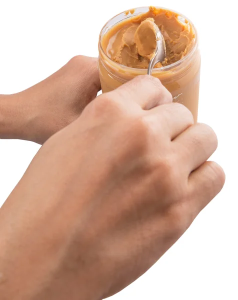 Main féminine avec beurre d'arachide — Photo