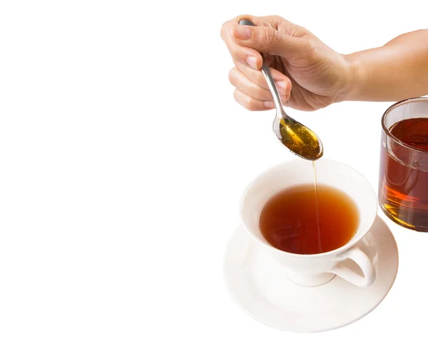 Ženská ruka míchání medu s čajem — Stock fotografie