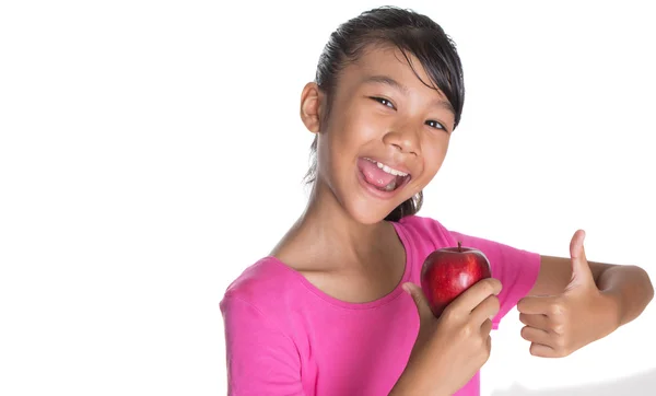 Chica joven con manzana y pulgares hasta signo —  Fotos de Stock