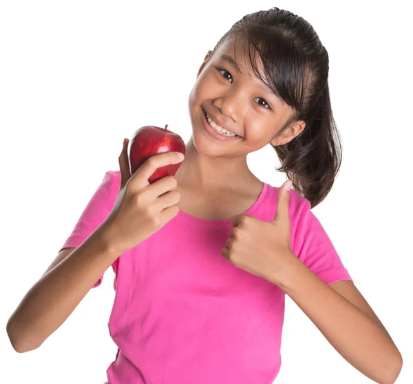 Chica joven con manzana y pulgares hasta signo —  Fotos de Stock