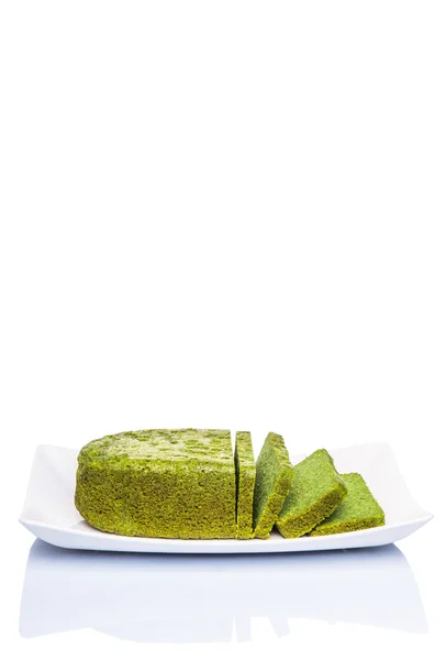 Pandan chiffon cake (flavoured with the juice of Pandanus amaryllifolius leaves) in white plate over white background