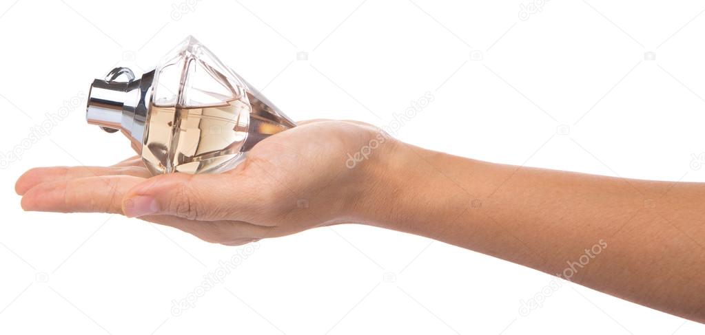 Female Hand Holding Bottle Of Perfume