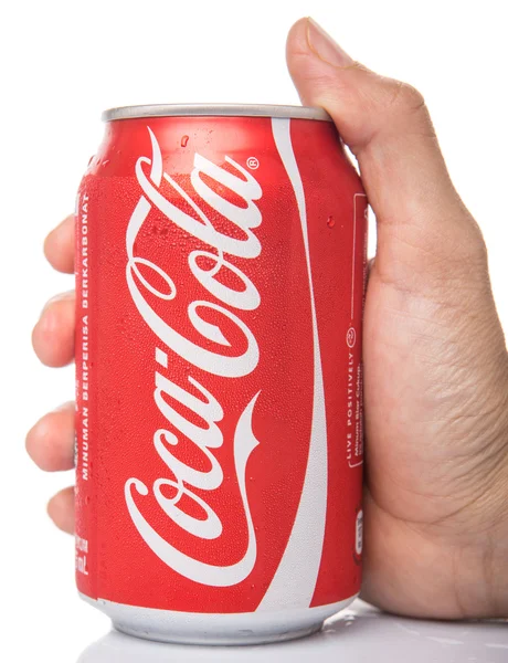 Holding a Coca Cola is — Stock Fotó