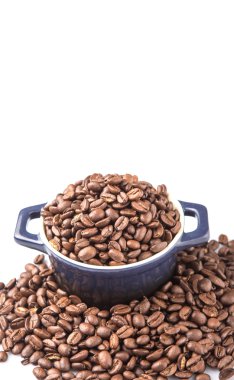 Mavi seramik tencerede kavrulmuş kahve çekirdekleri