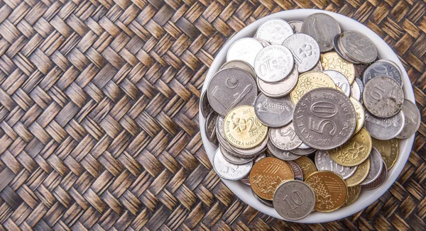 Coins In White Bowl Stock Image