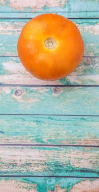 Turuncu domates yıpranmış ahşap arka plan üzerinde