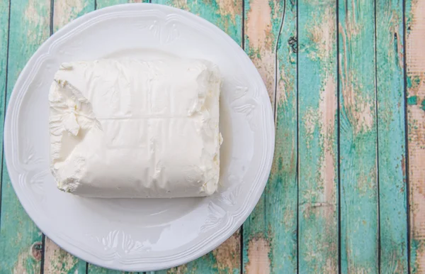 Um bloco de queijo creme — Fotografia de Stock