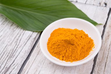 Zerdeçal tozu ve zerdeçal yaprakları