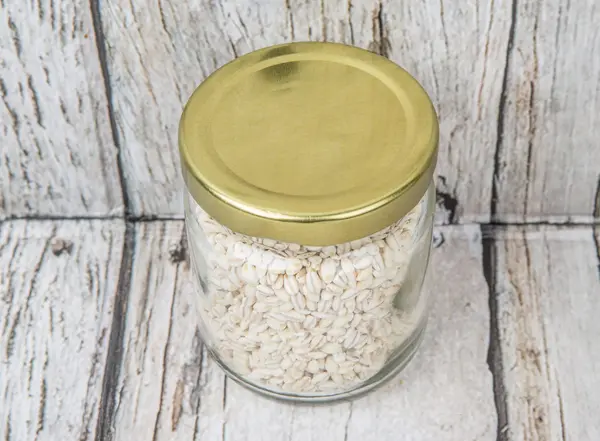 White millet in mason jar — Stock Photo, Image