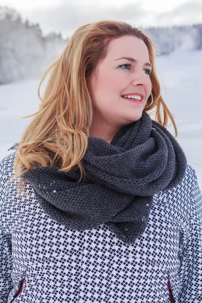 Portrait of a blond chubby woman in winter jacket and thick scarf. — Stock Photo, Image