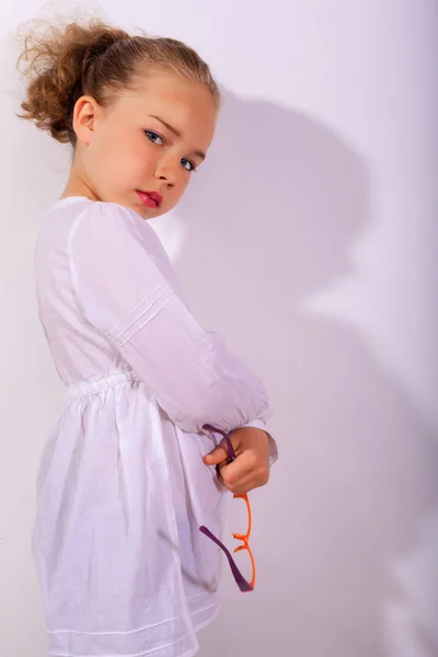 Blond girl with crossed arms and glasses in the hand — Stock Photo, Image