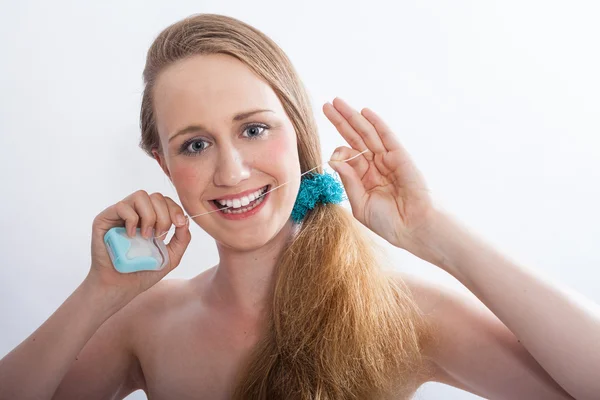 Young Woman Flossing Teeth in White Studio — Stock Photo, Image