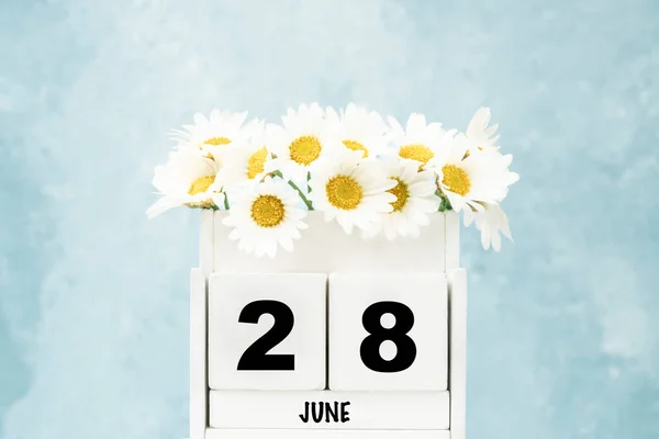 Vit Kub Kalender För Juni Med Tusensköna Blommor Över Blå — Stockfoto