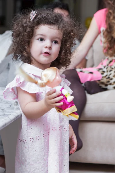 Girl playing with a doll — Stock Photo, Image