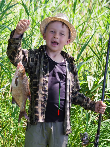 Young fisherman caught a bream — Stock Photo, Image