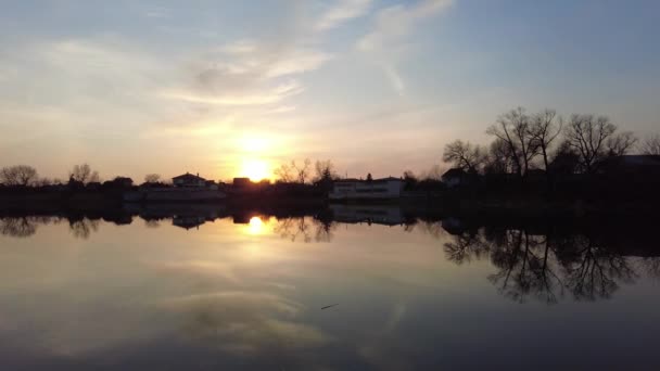 日落时 河岸上美丽的风景 日出在河岸附近的河边 美丽的冬夜在河边 冰在春天融化 在水面上融化 — 图库视频影像