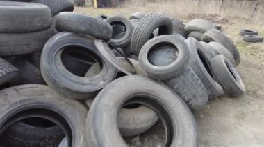 a mountain of old tires. dump of used wheels. Industrial landfill for the processing of waste tires and rubber tires. Pile of old tires and wheels for rubber recycling. Tire dump