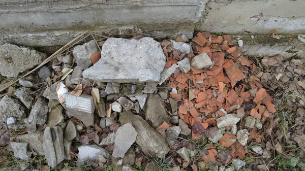 a pile of construction waste. broken brick and concrete. shards of red brick