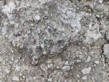 Yol dokusu. Gri taşlar. Çöplük sürtüğü. gri beton