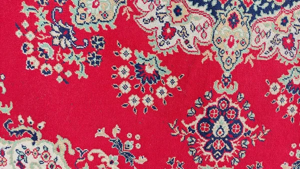 pattern on the carpet. old woolen carpet. vintage handmade carpet. ancient ornament on the fabric