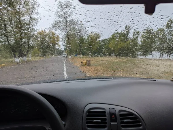 raindrops on the glass of the car. inside the car in the rain. auto autumn rain