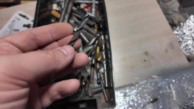 Matkap uçları. Elektrikli matkapla beyaz bir duvarı delmeye yakın plan. İnşaata odaklan. İnşaat, yenileme, DIY projeleri, inşaat aracı reklamcılığı, eğitim.