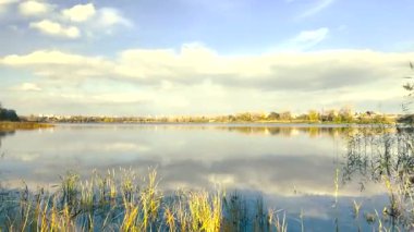 Beautiful autumn landscape with a lake and blue water. Retro-style landscape. Unusual colors. Sunset on the lake. 4K 60fps.